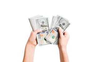 Isolated image of female hands counting dollars on white background. Top view of salary and wages concept photo
