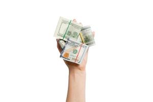 Top view of female hand holding a lot of rolled up dollar banknotes on white isolated background. Poverty concept. Credit concept with copy space photo