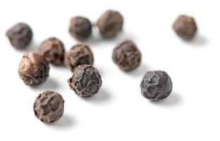 Dry black pepper isolated on white photo