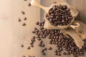 roasted coffee beans in wood scoop photo