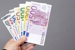 European money in the hand on a gray background photo