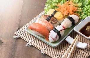 sushi with sauce and wasabi on wood plate photo