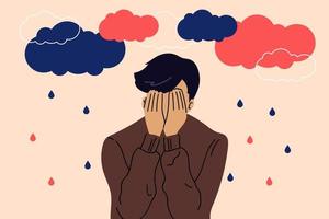 Sad, unhappy young man under dark clouds and rain. Psychology, depression, bad mood. Vector illustration in cartoon flat style.