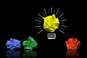 Light Bulb Icon and Colorful Crumpled Papers - Idea, Creativity Concept photo