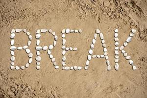 Break - Word Made with Stones on Sand photo