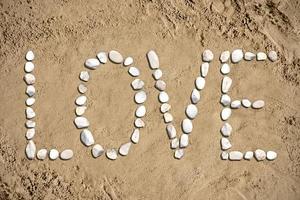 Love - Word Made with Stones on Sand photo