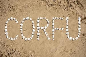 Corfu - Word Made with Stones on Sand photo