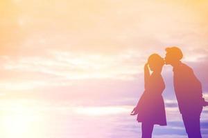 Young couple in love at sunset on the Mountain photo