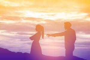 Silhouette of a angry woman and man on each other photo