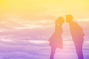 Young couple in love at sunset on the Mountain photo