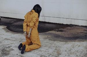 Prisoner in orange robe concept,Portrait of asian woman in Prison uniforms on white background, photo