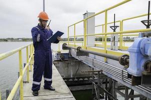 Water plant maintenance technicians, mechanical engineers check the control system at the water treatment plant. photo