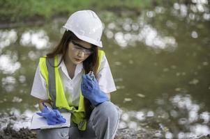 Environmental engineers inspect water quality,Bring water to the lab for testing,Check the mineral content in water and soil,Check for contaminants in water sources. photo