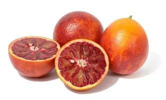 Whole and half red orange on white isolated background, delicious citrus photo