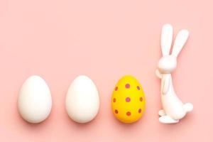 Happy Easter. Close-up of three easter eggs next to easter bunny with copy space for text photo