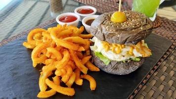 Fresh delicious burger and French fries with sauces. photo