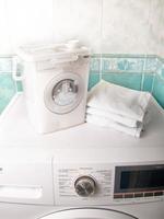 Containers for storing washing powder for different fabrics on a washing machine photo