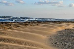 Sand dunes by the sea photo