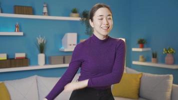 Happy Asian woman dancing alone at home. Happy Asian woman immersing herself in dancing alone in the hall. video