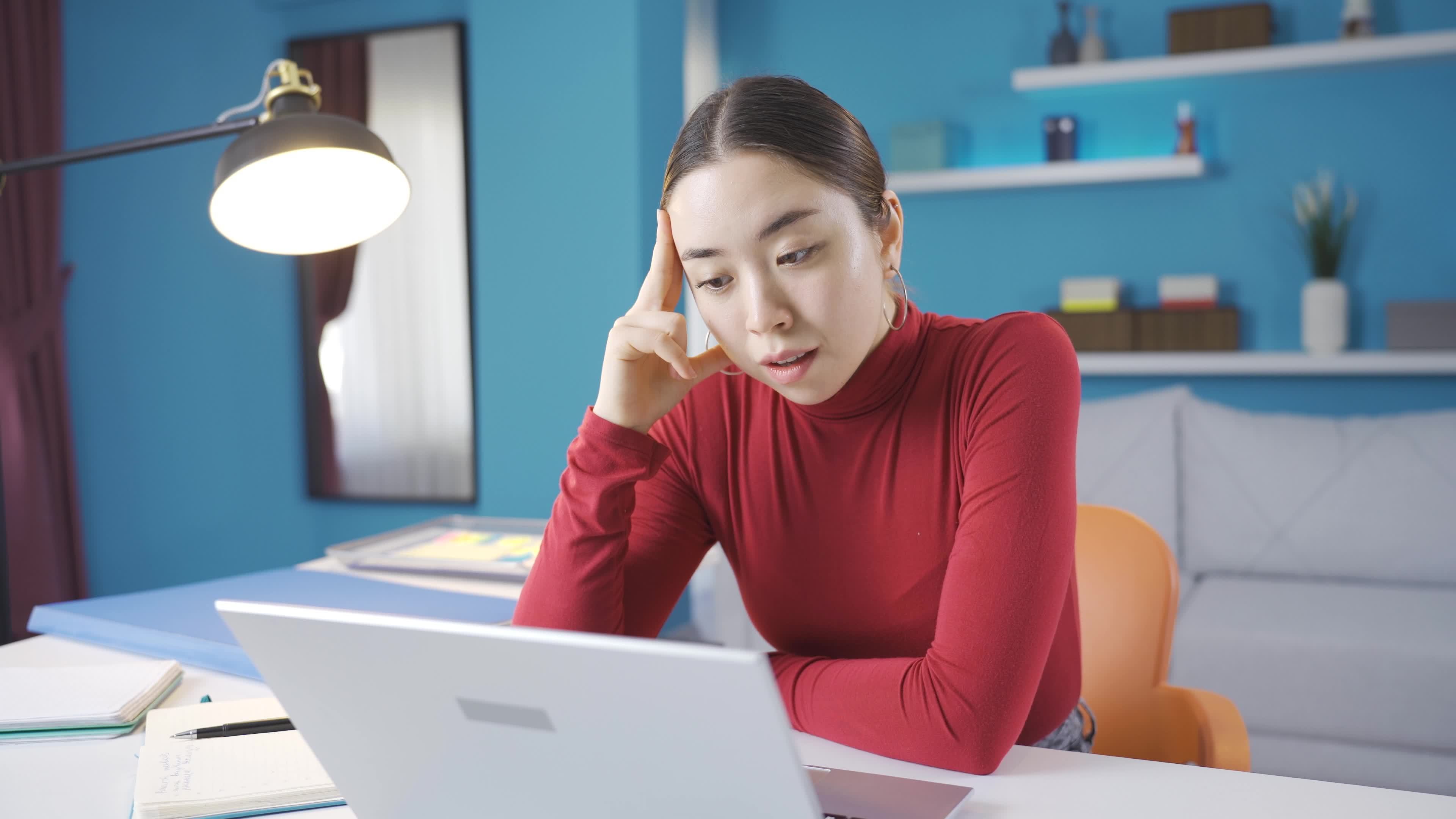 Tired Asian woman with headaches, tired from working hard, looking at