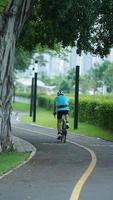 Guangzhou City, China, 2022 - One biker riding the bicycle through the exercise road in the park photo