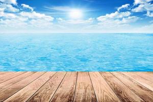 Wood floor with ocean in sunshine day photo