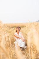 Young Asian women  in white dresses  in the Barley rice field photo