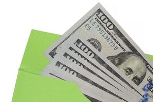 close up of dollars in green envelope against white photo