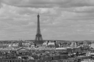 view on roofs of buildings and Eiffel Tower in Paris photo