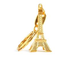 golden Eiffel tower keychain isolated on white photo