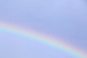 close up of rainbow in a blue sky photo