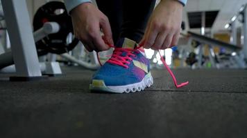 Running shoes - woman tying shoe laces in the gym video