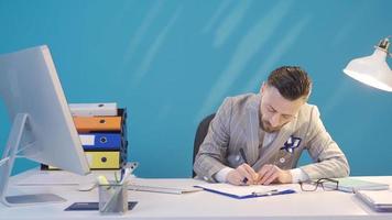 Portrait of businessman working intensely and feverishly. Elegant and charismatic businessman working feverishly and intensely at his desk. video