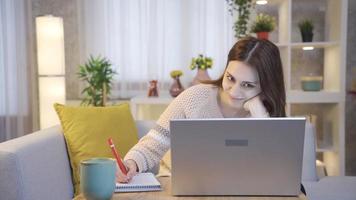 freelancer vrouw werken Aan laptop in leven kamer Bij huis. portret van gelukkig jong vrouw werken van een afstand online Bij laptop Bij huis. video