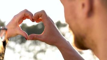 Young couple in love taking photo of themself on a film camera. Slow motion video