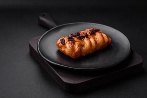 Delicious fresh baked pigtail bun with nuts and syrup photo