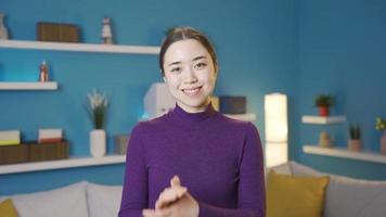 Loving Asian young woman making a sign of unity and togetherness in the name of peace and friendship. video