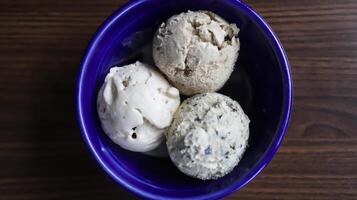 Homemade ice cream on a blue ceramic bowl. photo