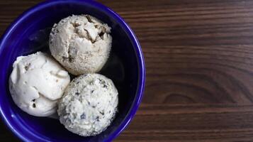 Homemade ice cream on a blue ceramic bowl and some copy space to write text. photo