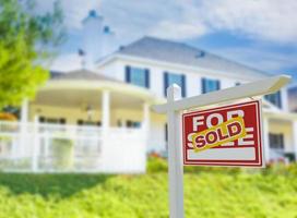 Sold For Sale Real Estate Sign in Front of New House. photo