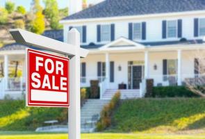 For Sale Real Estate Sign in Front of New House. photo