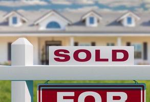 Sold For Sale Real Estate Sign in Front of New House. photo