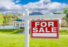 For Sale Real Estate Sign in Front of New House. photo