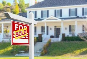 Sold For Sale Real Estate Sign in Front of New House. photo