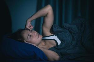 Asian women have a high concern that is why she can't sleep.Have stress from work photo