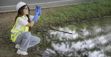 Environmental engineers inspect water quality,Bring water to the lab for testing,Check the mineral content in water and soil,Check for contaminants in water sources. photo