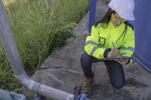 Environmental engineers work at wastewater treatment plants,Female plumber technician working at water supply photo