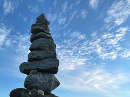 Pyramid of stones against the sky, the concept of balance. photo