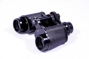 Binoculars on light background photo