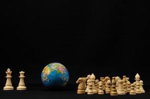 Chess pieces and globe photo